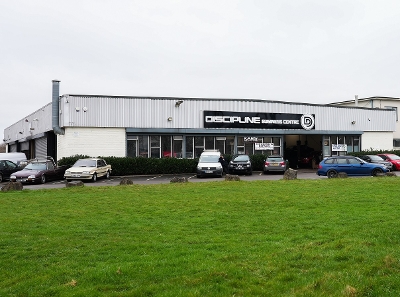 Front shot of The Discipline Centre with a car park and grassy area in front